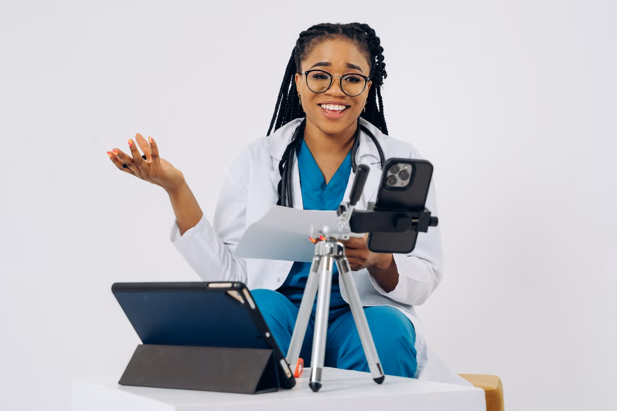 Doctor conducting a virtual consultation on a smartphone and tablet